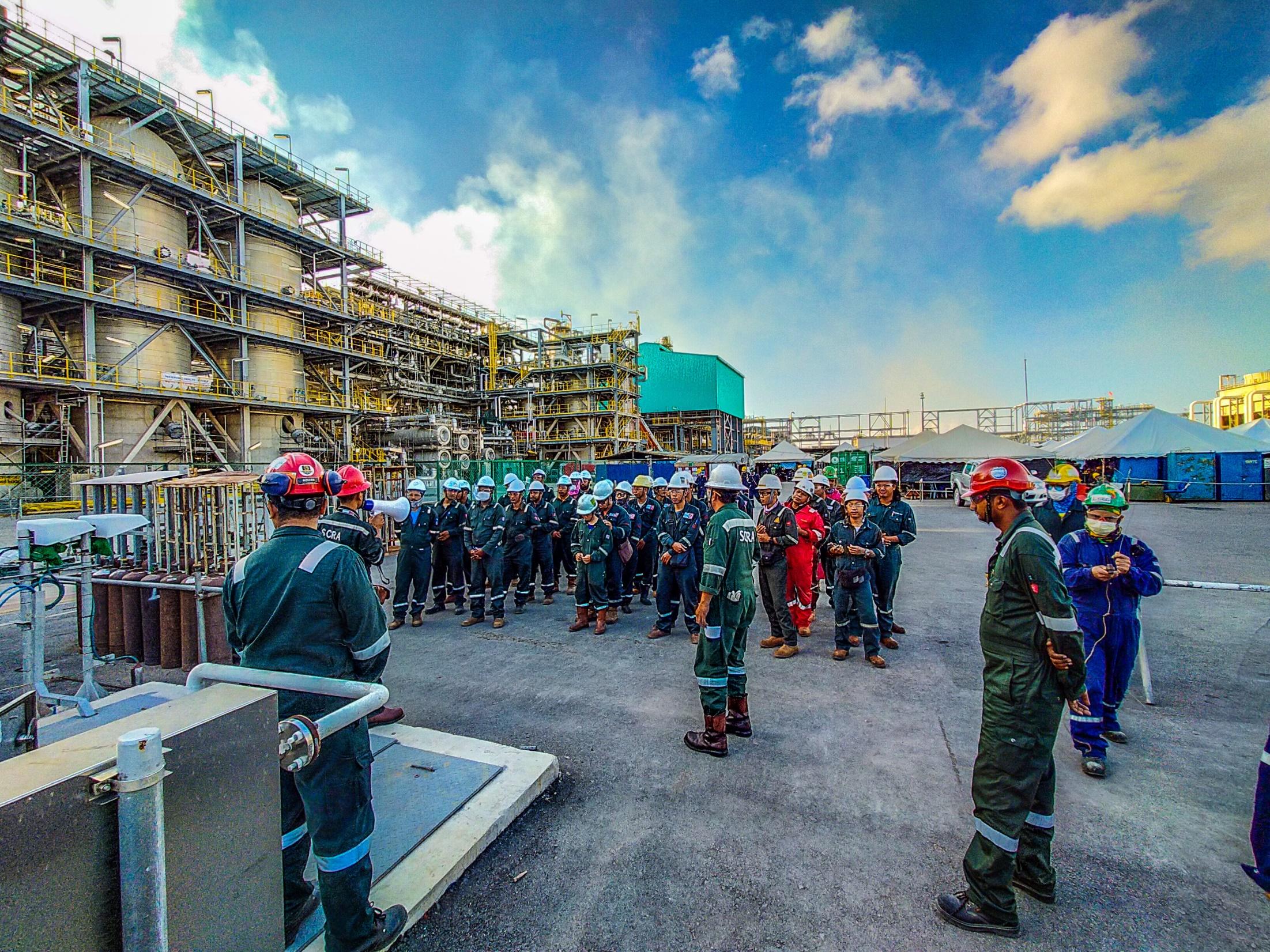 Malaysia oil and gas site team during a field briefing